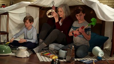 Image of a grandmother and two grandchildren playing music